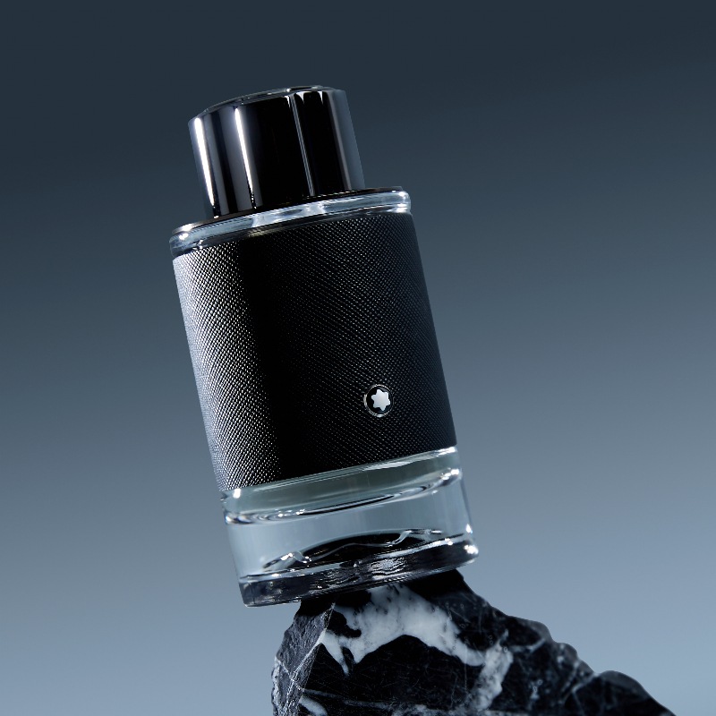 montblanc explorer bottle balanced on top of black cliff edge