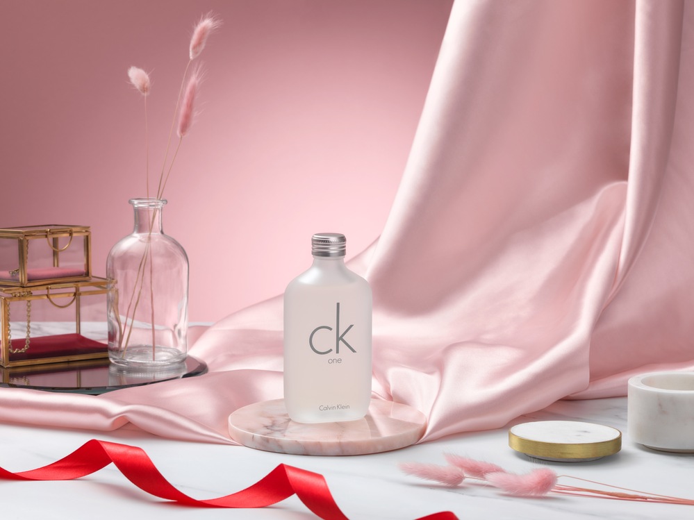 CK One by Calvin Klein with pink draped background