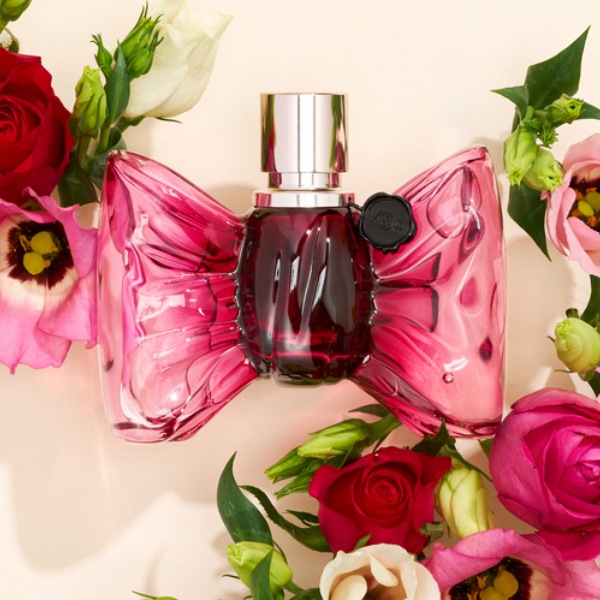 Bonbon by Viktor & Rolf with pink and red roses surrounding bottle