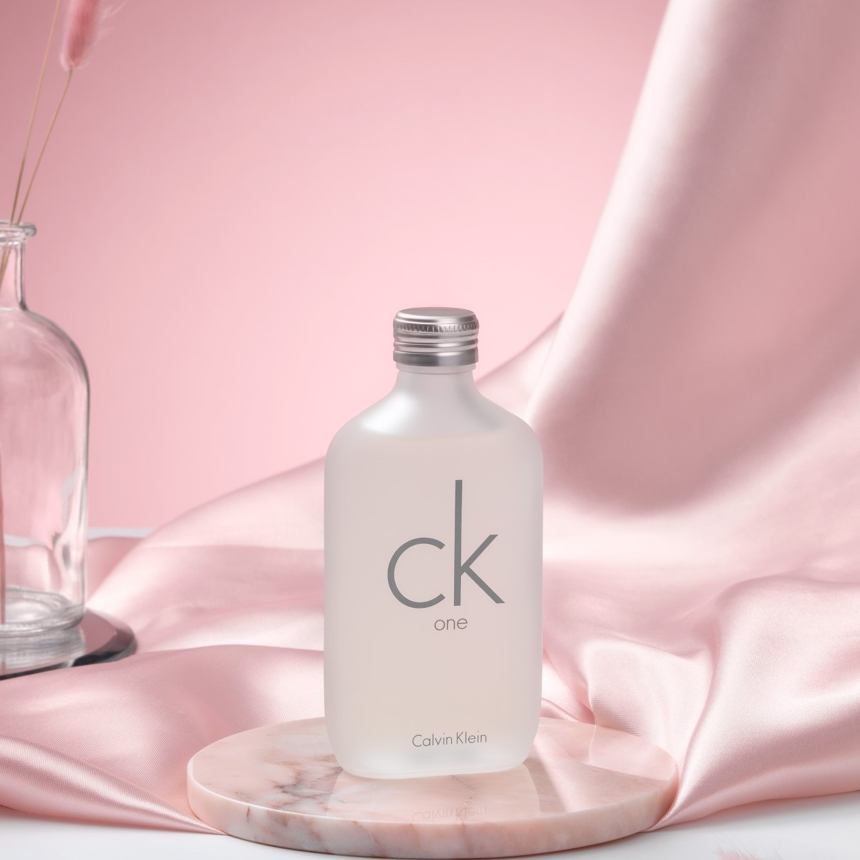 Calvin Klein CK One perfume with pink draped background