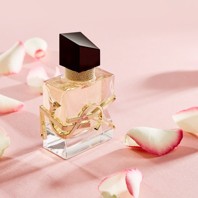 Libre by YSL with pink background and pink rose petals