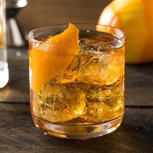 Old fashioned cocktail in a glass with slice of orange