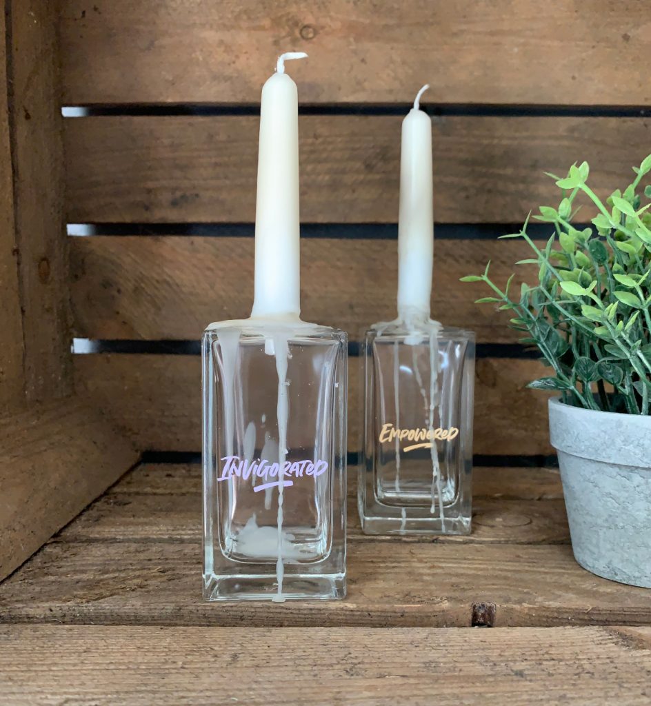 Ucycled perfume bottles holding a candle