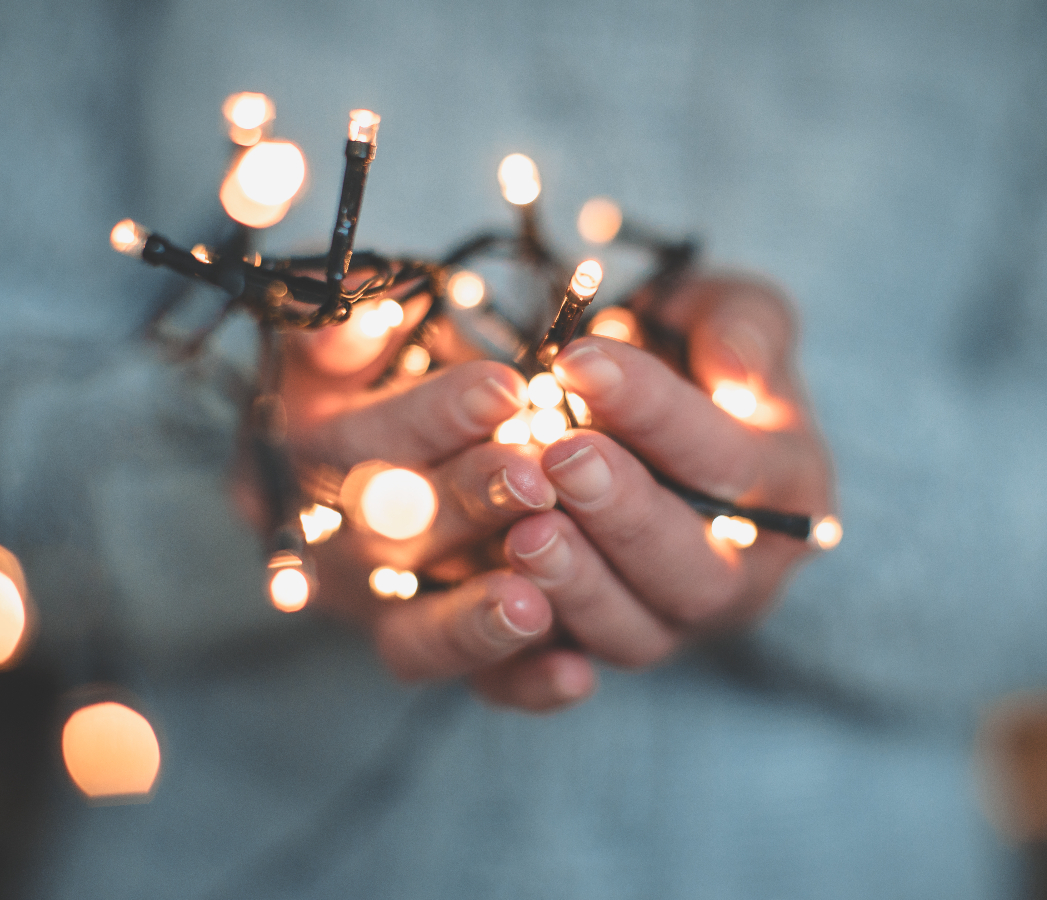 Person holding fairylights in cupped hands