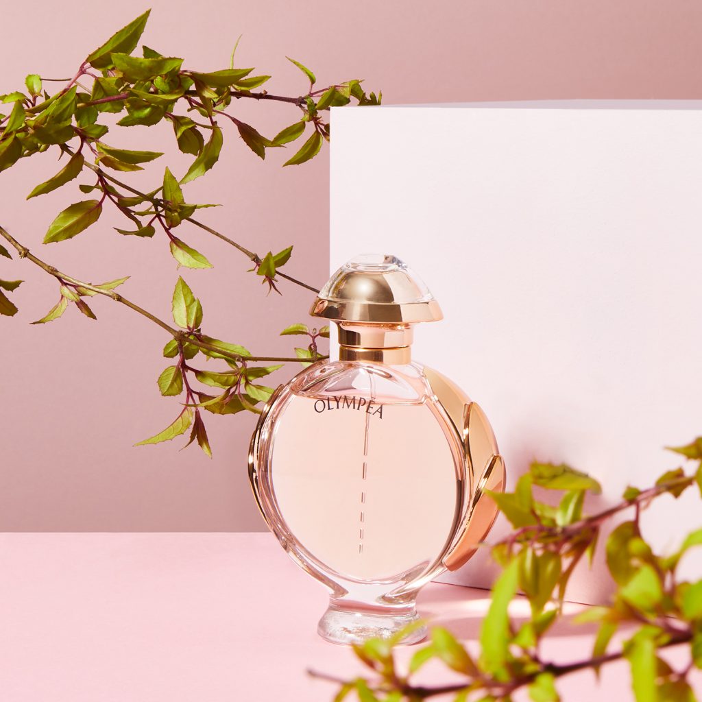 Olympea by Paco Rabanne with green leaves and pink background
