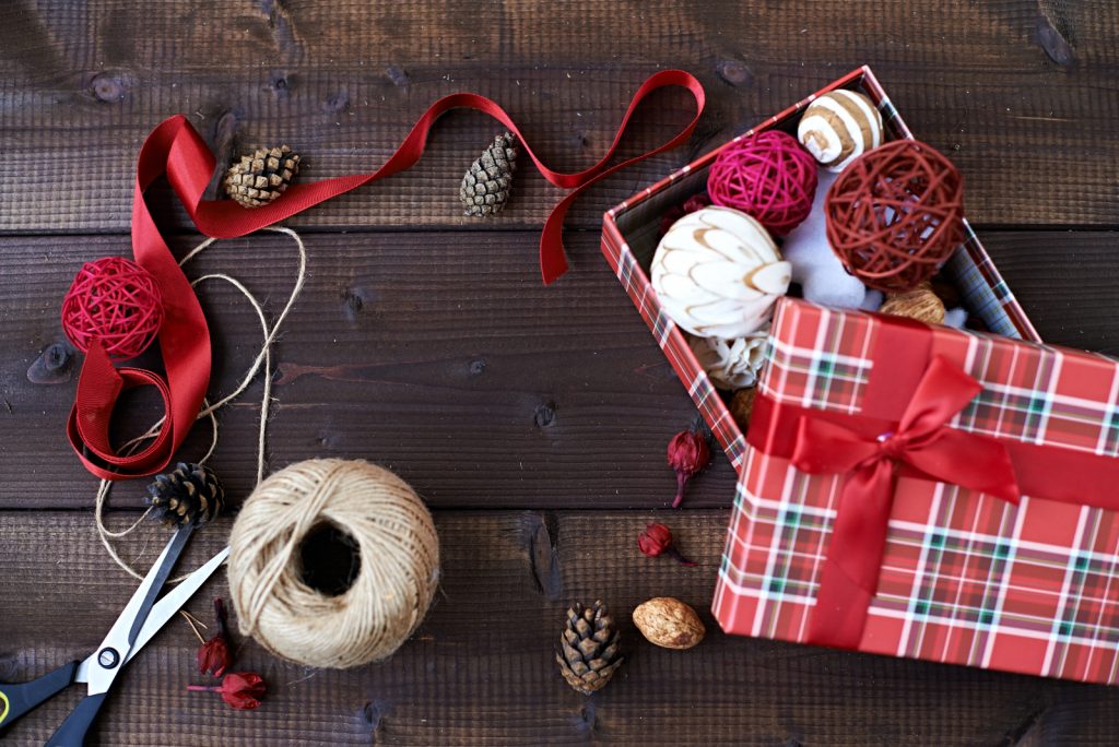 Red ribbon and other Christmas decorations in craft box