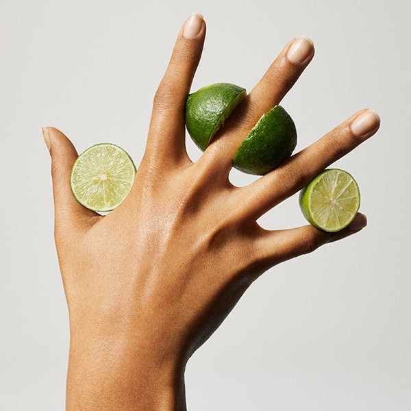 Hand holding lime slices