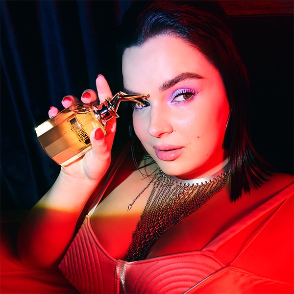 Model holding bottle to her face