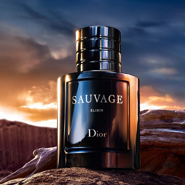 Sauvage elixir with desert and sunset in background