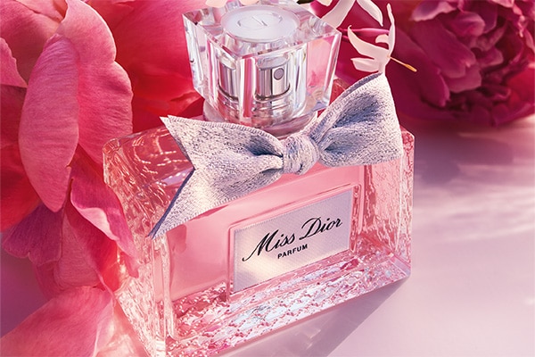 Miss dior parfum bottle surrounded by flowers