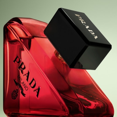 Prada Paradoxe Radical Essence bottle on a green background