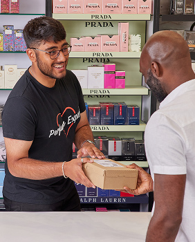A man collecting his purchase in store from the perfume shop