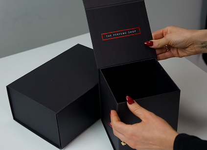 A black gift box with The Perfume Shops logo on it