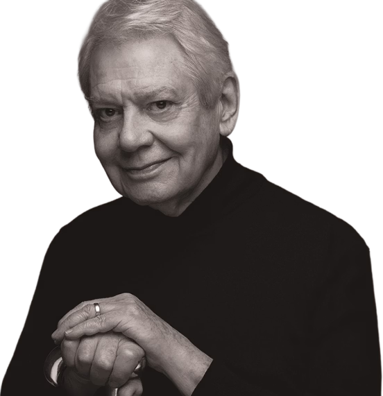A man in a black jumper smiling