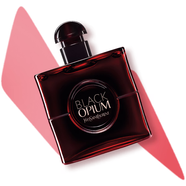 A bottle of black opium laid flat on a red lightening bolt shape