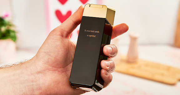 A hand holding. abottle of Rabanne 1 Million with an engaved message on the back