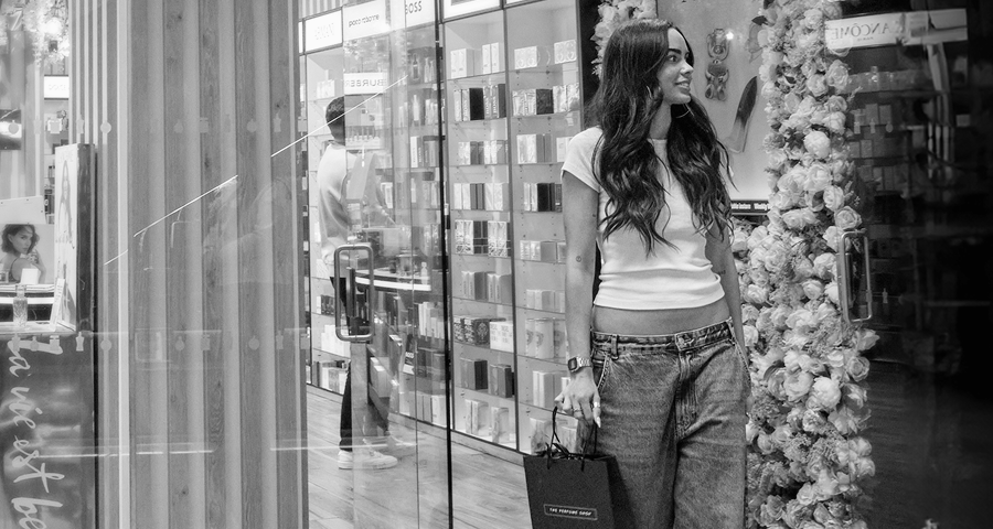 A girl browsing a Perfume Shop store