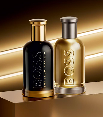 Two bottles of Hugo Boss sat on a gold plinth with diagonal lights behind them