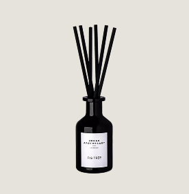 A black diffuser with a white label on it