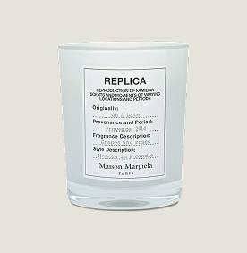 A white candle with orange writing