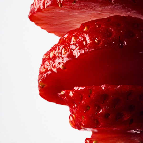 Close-up of fresh red strawberries with juicy texture, representing a sweet and vibrant fruity fragrance note