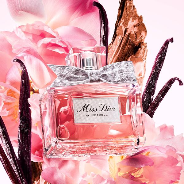 A bottle of Miss Dior EDP floating in some flowers and vanilla