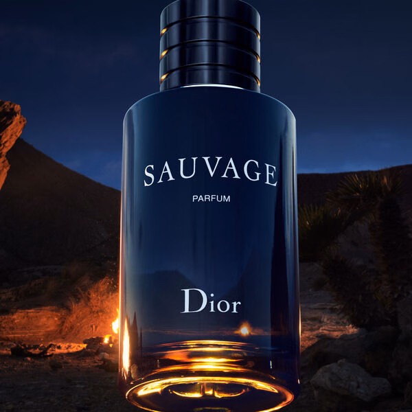 A bottle of the parfum with a camp fire behind