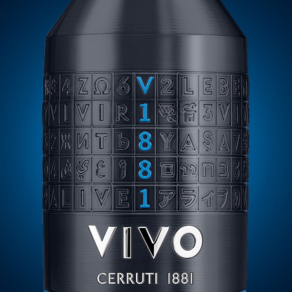 Cerruti 1881 VIVO Elixir Eau de Parfum showing a single, monolithic fragrance bottle with a dark metallic blue–anthracite cap and an engraved grid pattern. The glass body features a translucent blue gradient fading into warm amber at the base, with “VIVO” and “CERRUTI 1881” embossed on the front, set against a deep, shadowy background that emphasises strength, intensity, and sophistication.