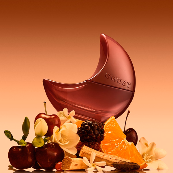 A bottle of Ghost Orb of Night with a gold background on some fruit