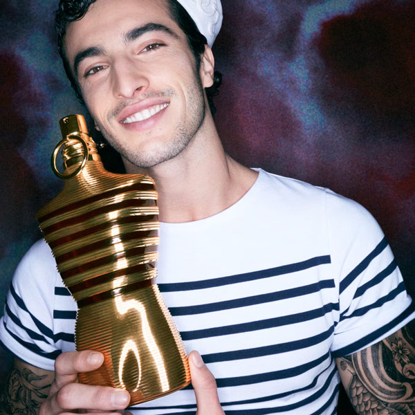 JPG model holidng a bottle of elixir perfume