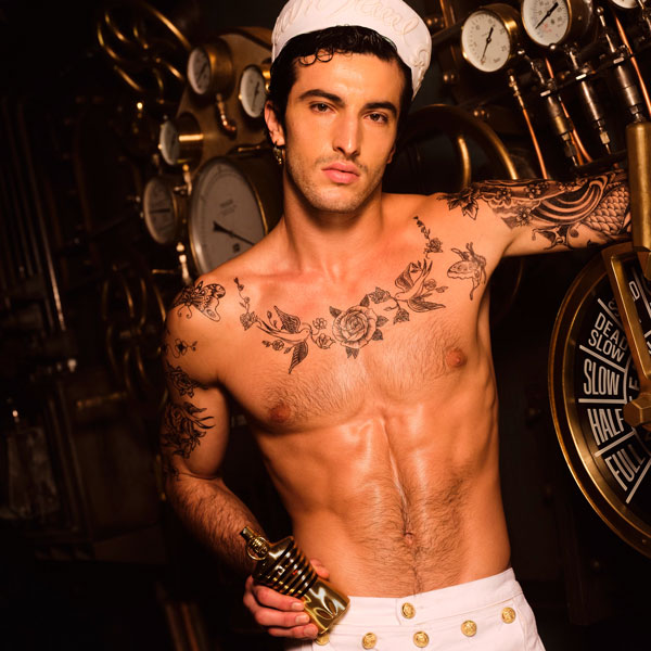 JPG male model holding a perfume bottle of JPG le male elixir