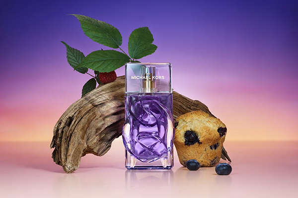 Michael Kors Violet Sunset with ingredients around it